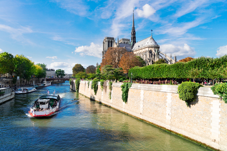 Notre Dame cathedral church over the Seine river with boat, Paris, Franceの写真素材
