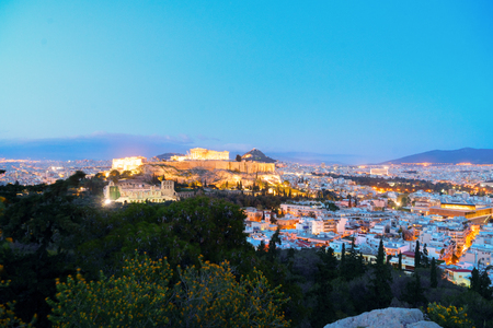 Famous skyline of Athens with Acropolis hill, Pathenon, Herodes Atticus amphitheater and Lycabettus Hill at night, Athens Greeceの写真素材