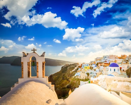 White church belfry and volcano caldera with sea landscape, beautiful details of Santorini island, Greece, tonedの写真素材