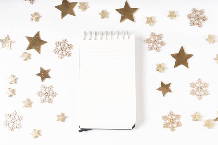 Wish list for Cristmas and New Year. Holiday decorations and ruled notebook with wish list on white desk, flat layの写真素材