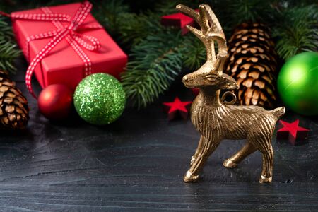 Christmas scene with deer and red git boxes, Christmas celebration and gift giving concept, copy space on wooden backgroundの写真素材