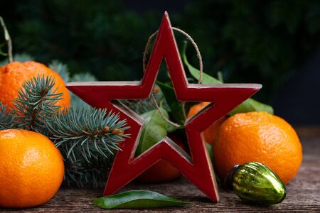Christmas scene with fresh tangeines and red starの写真素材