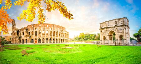Ruins of antique Colosseum and Arch of Constantine in sunrise lights, Rome Italy at fallの写真素材