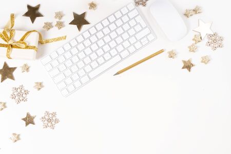 Christmas home office desk with computer, notebook, gifts, christmas gold decorations. Flat lay, top view, copy space.の写真素材