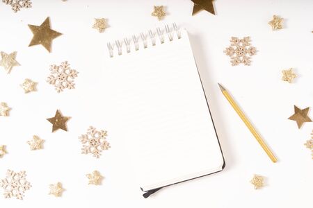 Wish list for Cristmas and New Year. Holiday decorations and ruled notebook with wish list on white desk, flat layの写真素材