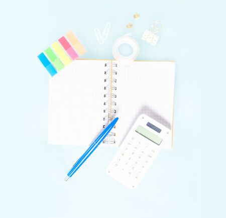 Back to school concept with school supplies on blue background, copy space on ruled paper notebook paperの写真素材