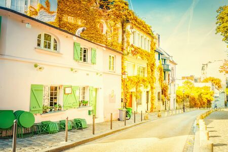 View of old street in quarter Montmartre in Paris, France. Cozy cityscape of Paris at summer. Architecture and landmarks of Paris at fallの写真素材