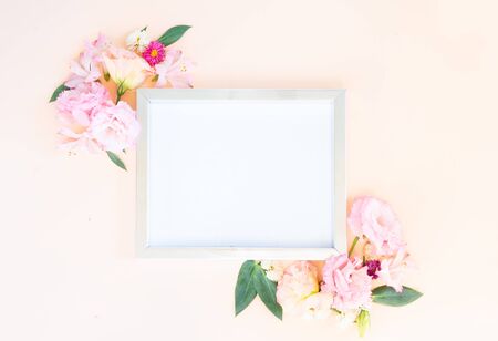 Flowers composition. Frame with lilly and eustoma flowers on pink background. Flat lay, top view scene.の写真素材