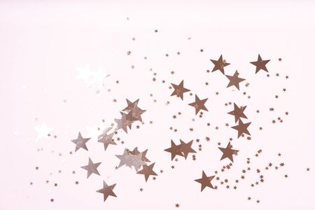 Christmas flat lay scene with golden stars, top view over pink