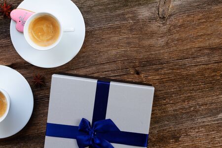 Valentines day cup of coffee with presemt box on wooden tableの写真素材