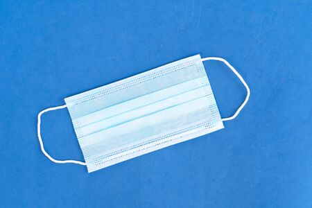 Healthcare and virus protection concept - virus protection mask over blue background