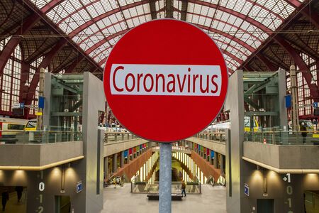 Coronavirus sign with railway station in backgroundの写真素材