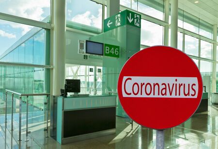 flight cancelation because of coronavirus concept, empty check in post in backgroundの写真素材