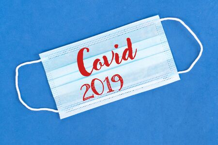 Healthcare and virus protection, covid 2019 concept - virus protection mask over blue background