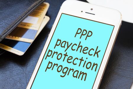 Paycheck Protection Program concept with phone screen with credit cards and walletの写真素材