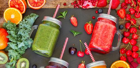 Fresh smoothy drinks in glass jars with igredientsの写真素材