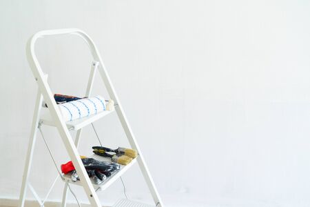 home renovation concept - old flat during restoration or refurbishment with white plaster walls and ladderの写真素材