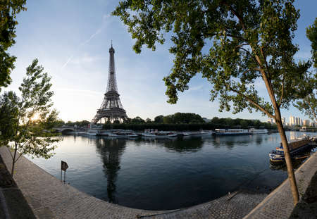 Paris Eiffel Tower and river Seine with sunrise sun in Paris, France. Eiffel Tower is one of the...
