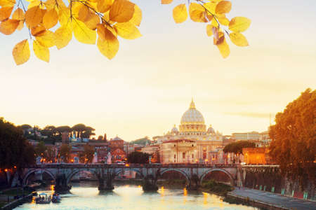 St. Peters cathedral over bridge and Tiber river in Rome at sunset, Italy at fall dayの写真素材