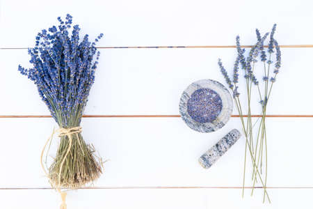 Bouquet and lavender flowers on white wooden boardの写真素材
