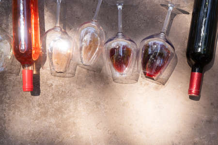 pink and and red wine in glasses with bottlesの写真素材