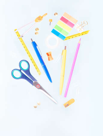 Back to school concept with school supplies falling on blue background with copy spaceの写真素材