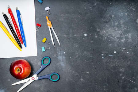 Back to school concept with colorful school supplies and apple on blackboard, top view background with copy spaceの写真素材