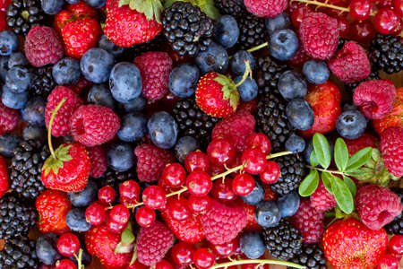 pile of freshh berries, top view food background