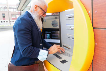 Senior man with ATM, Happy mature male using bank cash machine - Concept of business, banking...