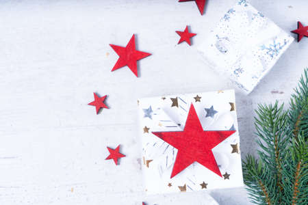 Christmas flat lay scene with gift boxes and red stars, Christmas celebration and gift giving concept, with copy space on wooden background close upの写真素材