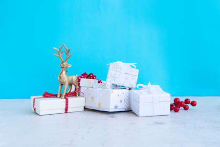Christmas flat lay scene with golden deer and set of gift boxesの写真素材