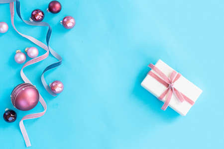 Christmas flat lay scene with ribbons, gift box and balls on aqua blue backgroundの写真素材