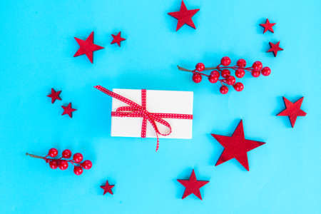 Christmas flat lay scene with stars and christmas gift boxes on aqua blue background