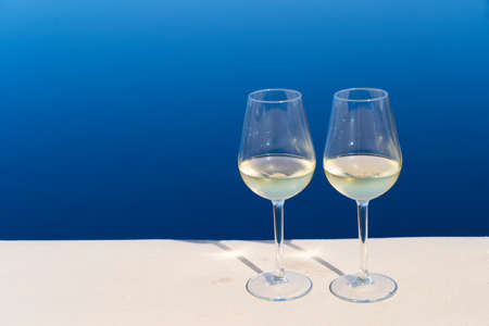 two glasses of wine with Aegaen sea in backgroundの写真素材