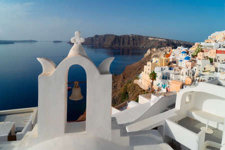 white church belfry and Oia landscape, beautiful details of Santorini island, Greeceの写真素材