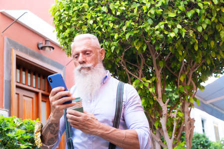 Senior hipster man with coffee and a phone, happiness, technology and elderly lifestyle people...