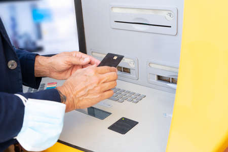 Senior man with ATM, mature male using bank cash machine, close up view - Concept of business,...