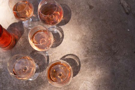 pink wine in glasses with shadows, top view close up, wine testing concept, shadows overlayの写真素材