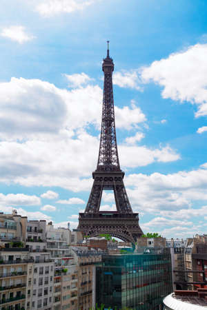 famous Eiffel Tower landmark and Paris roofs with clouds and sunshine, Paris Franceの写真素材