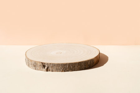 Minimal modern product display on textured beige background with wooden podiumの写真素材