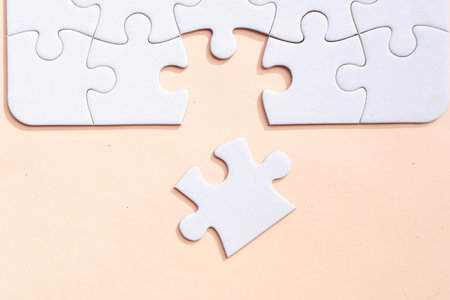 jigsaw puzzles with 1 unfitted piece on pink backgroundの写真素材