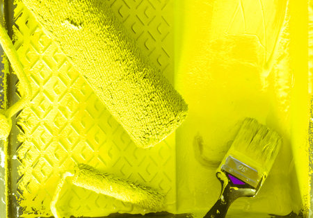 House renovation tools in illuminating yellow paint close upの写真素材