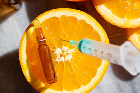 Citrus fruit vitamin c serum oil beauty care with syringe, anti aging natural cosmetic.の写真素材