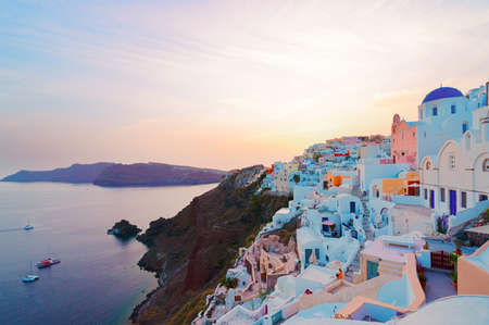 famous sunset over Oia village, Santorini island, Greece, tonedの写真素材