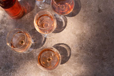 pink wine in glasses with shadows, top view close up, wine testing concept, shadows overlayの写真素材