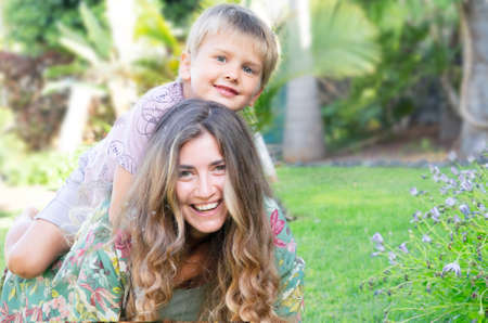 Mother playing with her son in gardenの写真素材