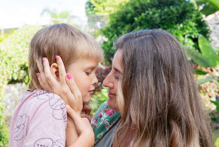 Mother playing with her son in gardenの写真素材