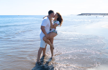 Happy young couple at the sea vacationsの写真素材