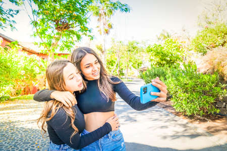 Two happy teenager girls making selfie shot together - friendsheep and youth concept, summer ourdoor activityの写真素材