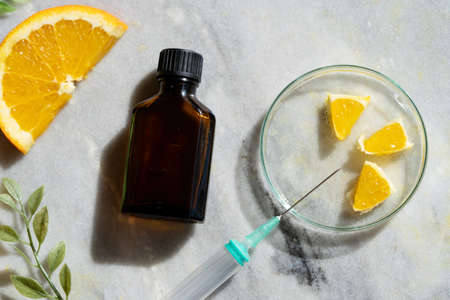 Citrus fruit vitamin c serum oil beauty care ingredient, anti aging natural cosmetic with natural ingridients, laboratory testing conceptの写真素材